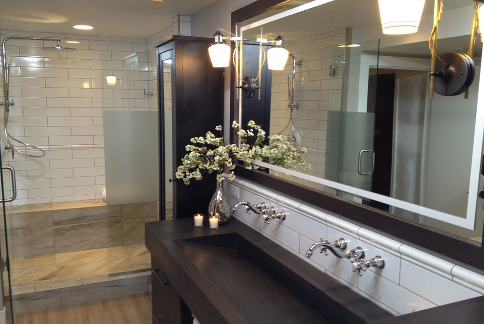 This is an example of a medium sized contemporary bathroom in Minneapolis with a trough sink, flat-panel cabinets, dark wood cabinets, concrete worktops, a freestanding bath, a double shower, a one-piece toilet, white tiles, ceramic tiles, white walls and vinyl flooring.