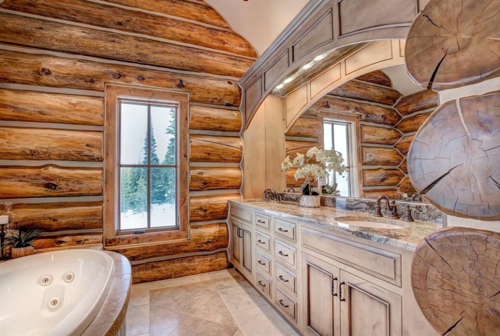 Photo of an expansive rustic ensuite bathroom in Other with beaded cabinets, beige cabinets, a built-in bath, a walk-in shower, beige walls, travertine flooring, a submerged sink, granite worktops, beige worktops, double sinks and a built in vanity unit.