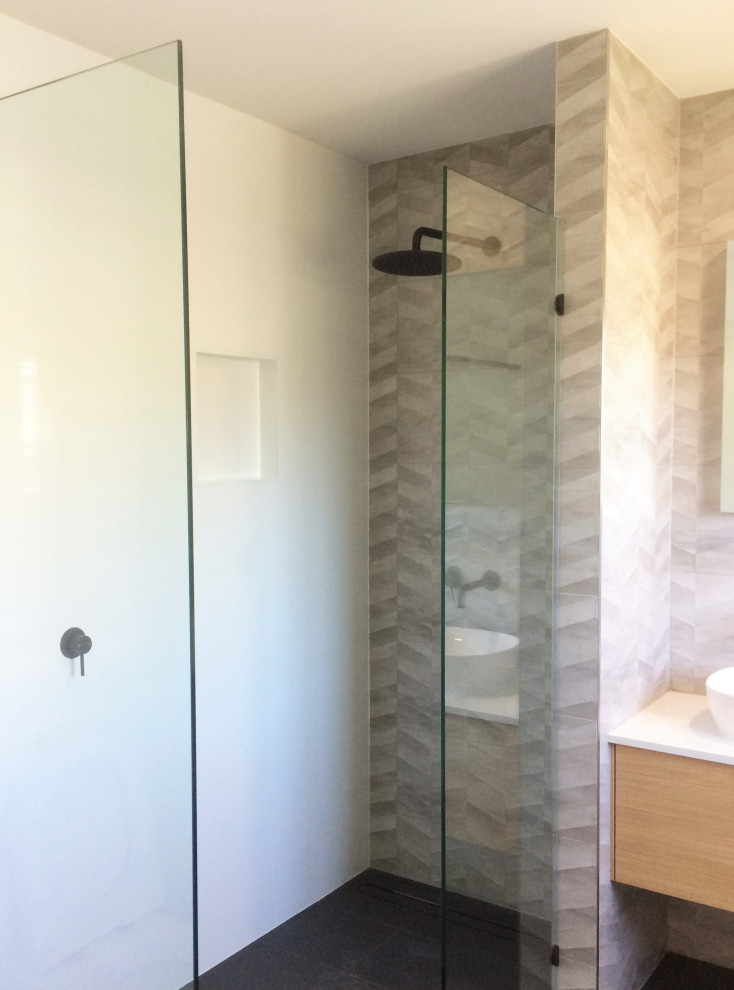 Bathroom - mid-sized contemporary kids' multicolored tile and ceramic tile ceramic tile, black floor and double-sink bathroom idea in Brisbane with flat-panel cabinets, medium tone wood cabinets, black walls, a vessel sink, quartz countertops, white countertops, a niche and a floating vanity