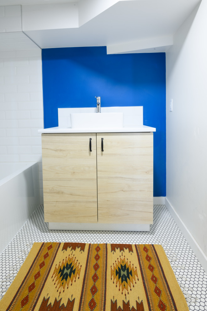 Inspiration för ett litet funkis vit vitt en-suite badrum, med släta luckor, skåp i ljust trä, ett platsbyggt badkar, en dusch/badkar-kombination, blå väggar och vitt golv