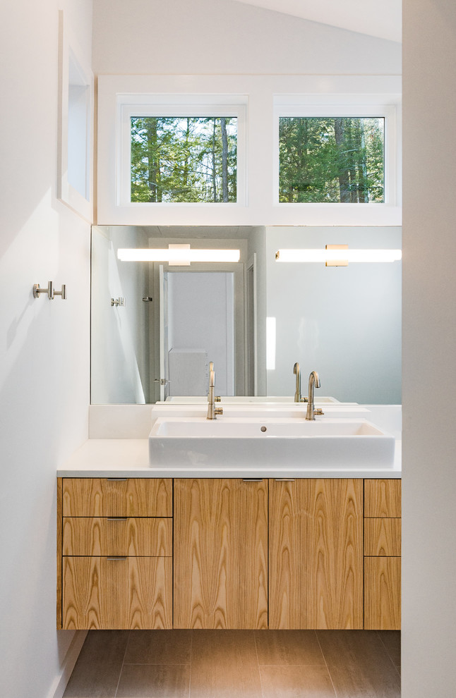 Photo of a contemporary shower room bathroom in Boston with flat-panel cabinets, medium wood cabinets, white walls, a vessel sink, engineered stone worktops and beige floors.