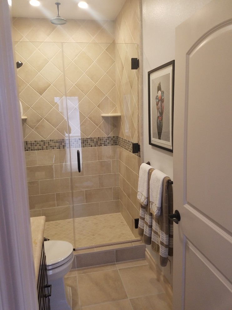 Idéer för mellanstora medelhavsstil badrum med dusch, med luckor med upphöjd panel, svarta skåp, en dusch i en alkov, en toalettstol med separat cisternkåpa, beige kakel, travertinkakel, vita väggar, travertin golv, ett undermonterad handfat, bänkskiva i kalksten, beiget golv och dusch med gångjärnsdörr