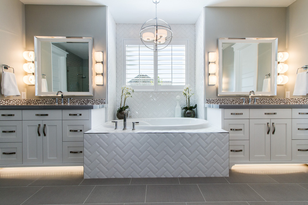 Example of a large arts and crafts master white tile and subway tile ceramic tile and gray floor drop-in bathtub design in Salt Lake City with shaker cabinets, white cabinets, gray walls, granite countertops and an undermount sink