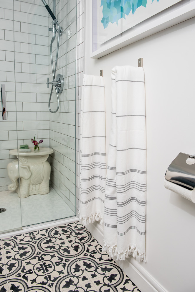 Inspiration for a mid-sized contemporary master black and white tile and cement tile cement tile floor alcove shower remodel in Other with flat-panel cabinets, black cabinets, a one-piece toilet, white walls, an undermount sink and quartzite countertops