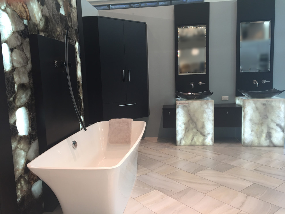 Example of a large minimalist master porcelain tile freestanding bathtub design in Phoenix with flat-panel cabinets, dark wood cabinets, a vessel sink, quartzite countertops and blue walls