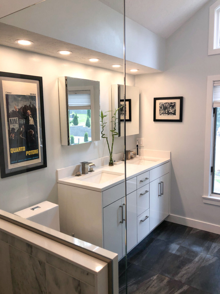 Design ideas for a classic ensuite bathroom in Boston with porcelain flooring, a submerged sink, a hinged door, double sinks and a built in vanity unit.