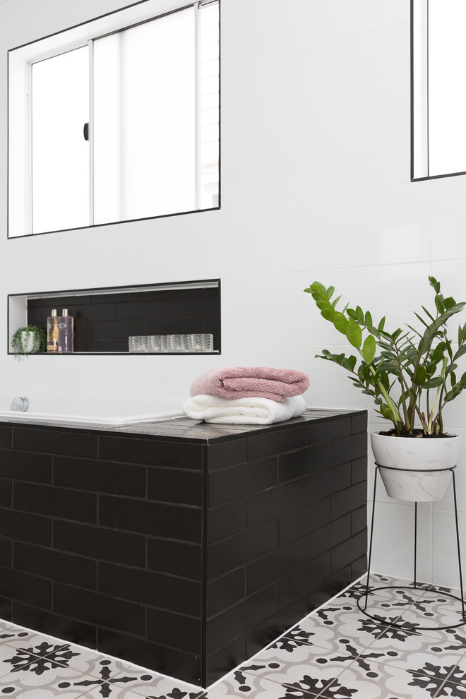 Contemporary bathroom in Brisbane with shaker cabinets, grey cabinets, a built-in bath, a shower/bath combination, white tiles and a submerged sink.