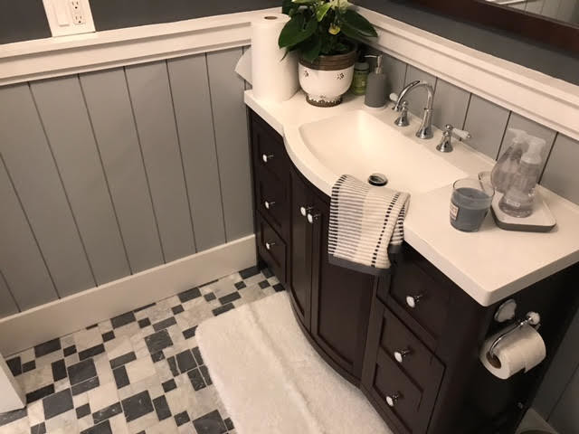 Small transitional 3/4 multicolored floor corner shower photo in San Francisco with furniture-like cabinets, black cabinets, a two-piece toilet, gray walls, an integrated sink and a hinged shower door