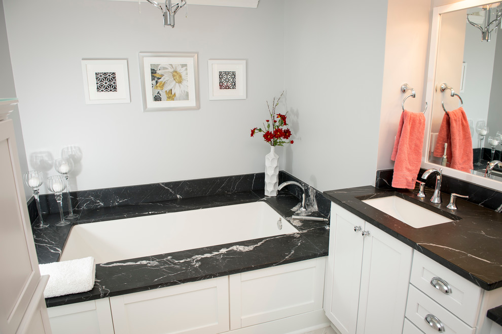 Beach style bathroom photo in Atlanta with an undermount sink, marble countertops, an undermount tub and white walls