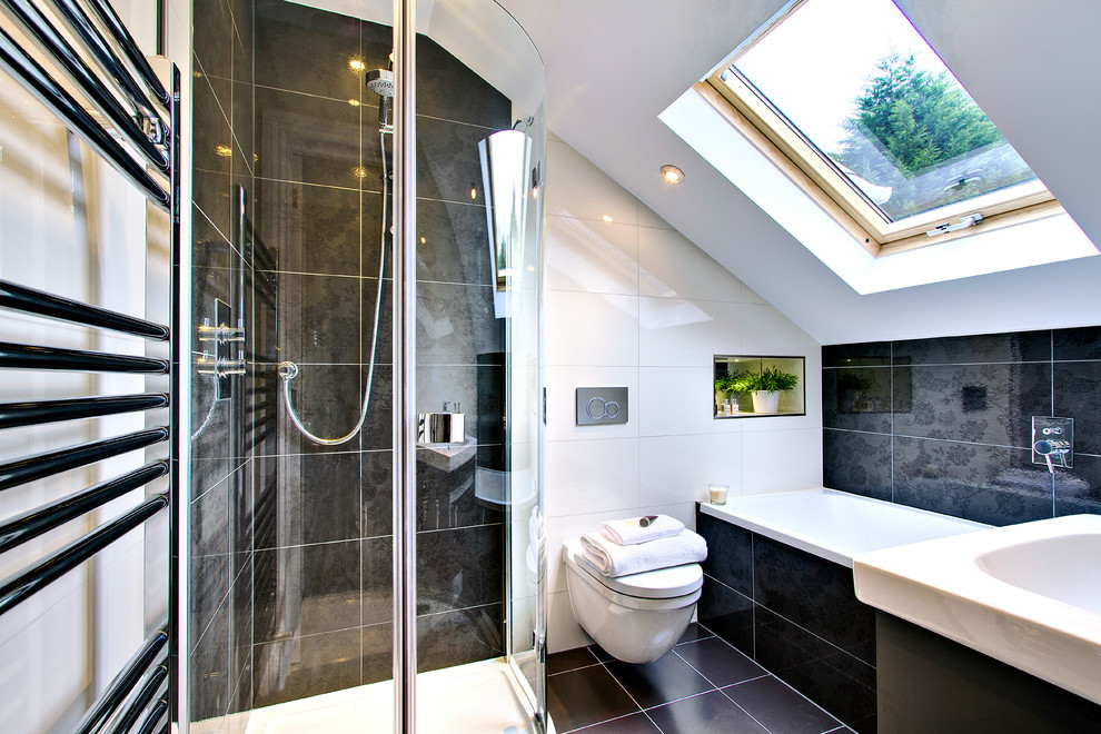 This is an example of a medium sized contemporary ensuite bathroom in Surrey with dark wood cabinets, a built-in bath, a walk-in shower, a wall mounted toilet, beige tiles, ceramic tiles, white walls, ceramic flooring, black floors and a sliding door.