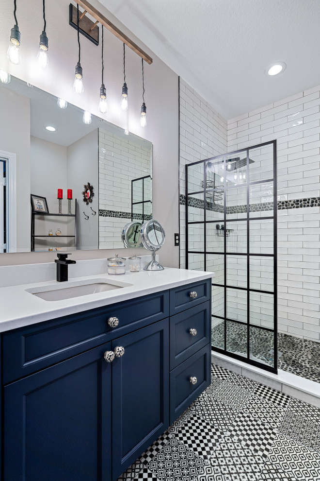 Large traditional shower room bathroom in Miami with shaker cabinets, blue cabinets, an alcove shower, white tiles, grey walls, a submerged sink, multi-coloured floors, white worktops, a single sink and a built in vanity unit.