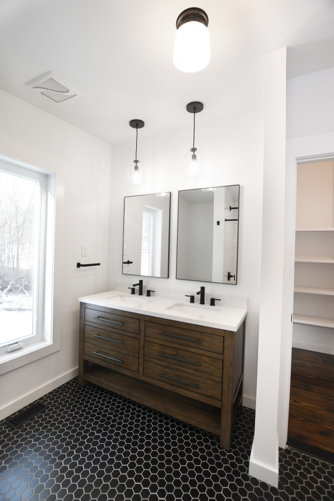 This is an example of a large midcentury ensuite bathroom in New York with freestanding cabinets, medium wood cabinets, a built-in bath, a shower/bath combination, a one-piece toilet, white tiles, ceramic tiles, white walls, ceramic flooring, black floors and a shower curtain.
