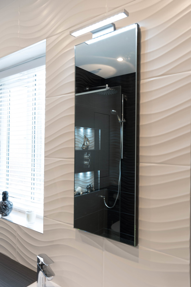 This is an example of a medium sized contemporary bathroom in Manchester with beaded cabinets, dark wood cabinets, a wall mounted toilet, black and white tiles, porcelain tiles, porcelain flooring, an integrated sink, solid surface worktops, white floors and an open shower.