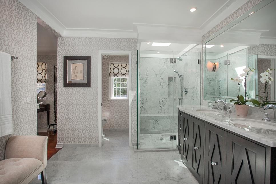 Example of a large classic master gray tile and ceramic tile ceramic tile corner shower design in Denver with raised-panel cabinets, dark wood cabinets, a two-piece toilet, multicolored walls, a drop-in sink and quartzite countertops