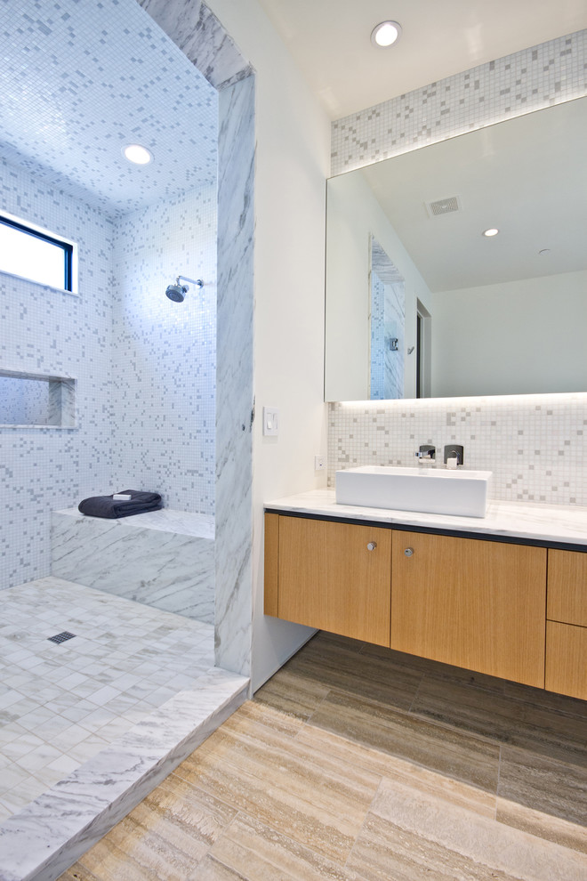 Inspiration for a contemporary bathroom in Phoenix with flat-panel cabinets, medium wood cabinets, a walk-in shower, grey tiles, white tiles, mosaic tiles, white walls, a vessel sink and an open shower.