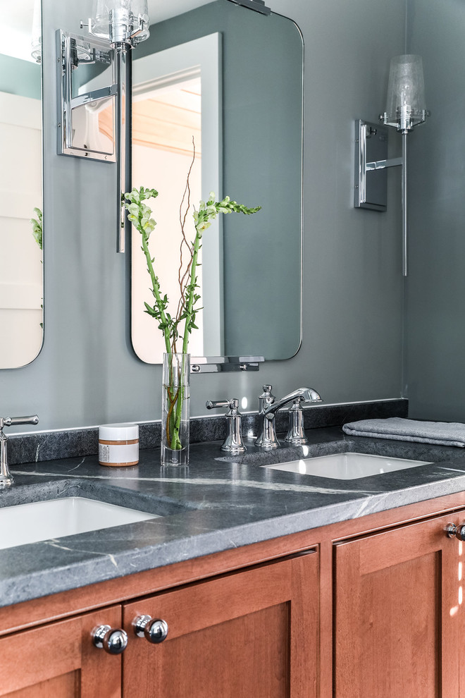 This is an example of a medium sized modern ensuite bathroom in Portland Maine with recessed-panel cabinets, medium wood cabinets, grey walls, a submerged sink, soapstone worktops, a hinged door and grey worktops.