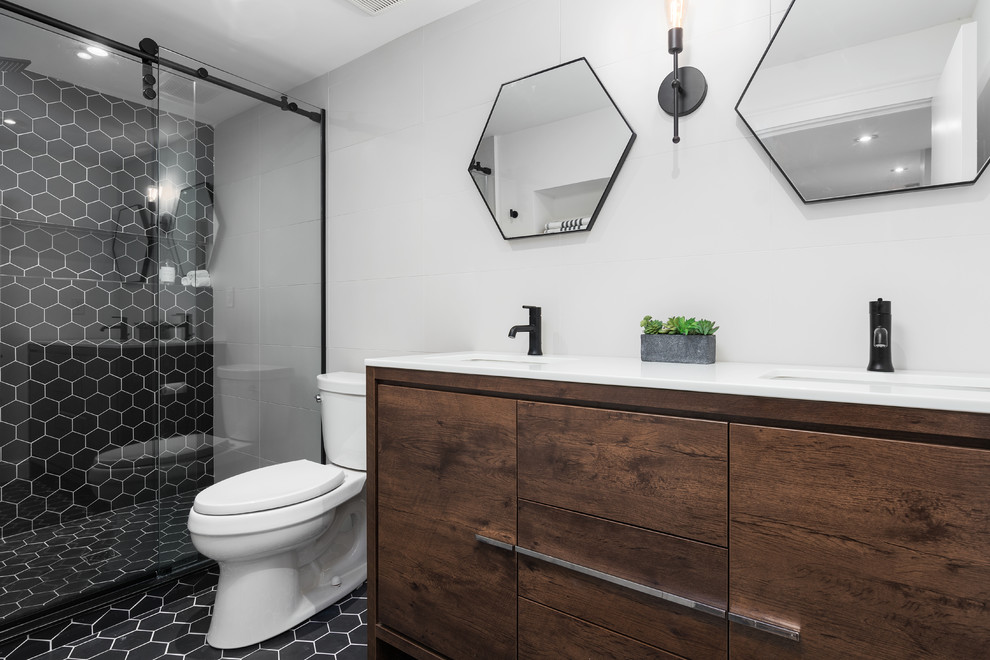 Exempel på ett mellanstort modernt en-suite badrum, med släta luckor, skåp i mellenmörkt trä, en dusch i en alkov, en toalettstol med separat cisternkåpa, svart och vit kakel, keramikplattor, vita väggar, klinkergolv i keramik, ett undermonterad handfat, bänkskiva i kvartsit, svart golv och dusch med skjutdörr