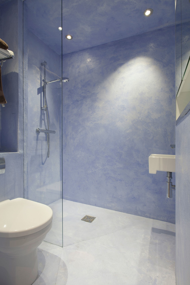 На фото: большая ванная комната в современном стиле с открытым душем, унитазом-моноблоком, синей плиткой, синими стенами, душевой кабиной и подвесной раковиной с