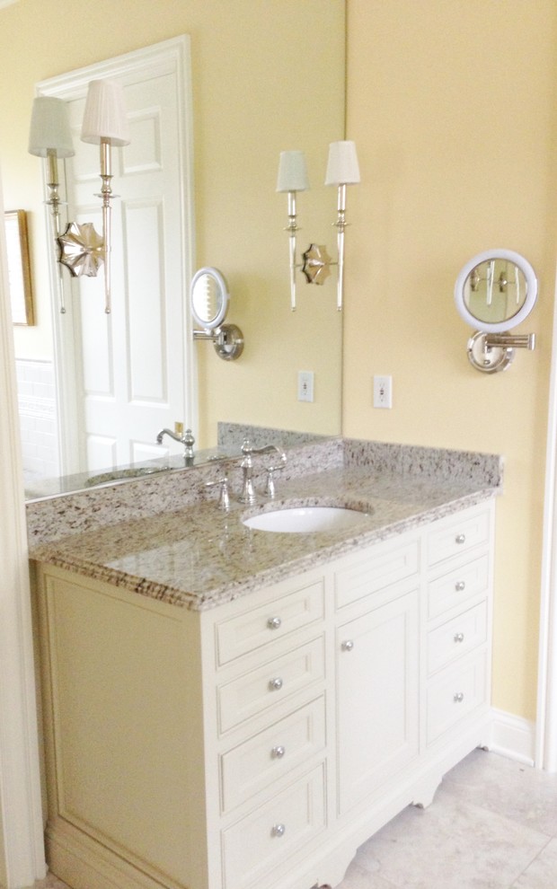 Photo of a large classic ensuite bathroom in Columbus with a submerged sink, beaded cabinets, beige cabinets, granite worktops, a built-in bath, a corner shower, a two-piece toilet, white tiles, ceramic tiles, yellow walls and porcelain flooring.