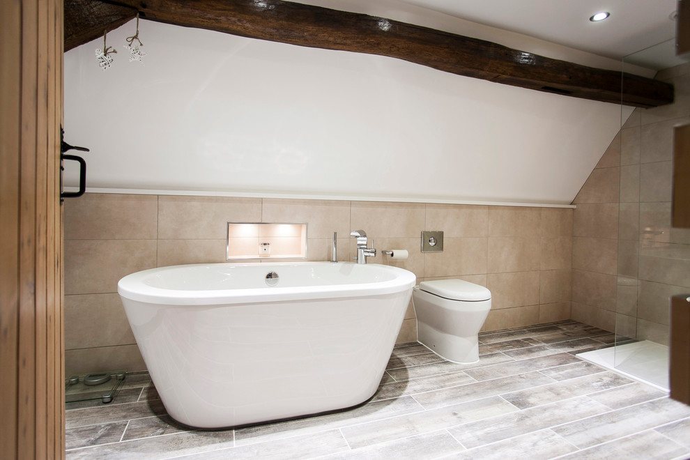 Inspiration for a medium sized classic family bathroom in Kent with a built-in sink, flat-panel cabinets, a freestanding bath, a walk-in shower, beige tiles, ceramic tiles, ceramic flooring, white cabinets, a wall mounted toilet, white walls, yellow floors, an open shower and white worktops.