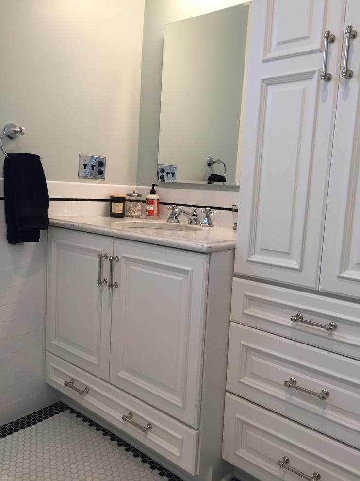 Example of a mid-sized classic kids' white tile and porcelain tile mosaic tile floor and white floor bathroom design in Newark with raised-panel cabinets, white cabinets, a two-piece toilet, blue walls, an undermount sink and quartz countertops