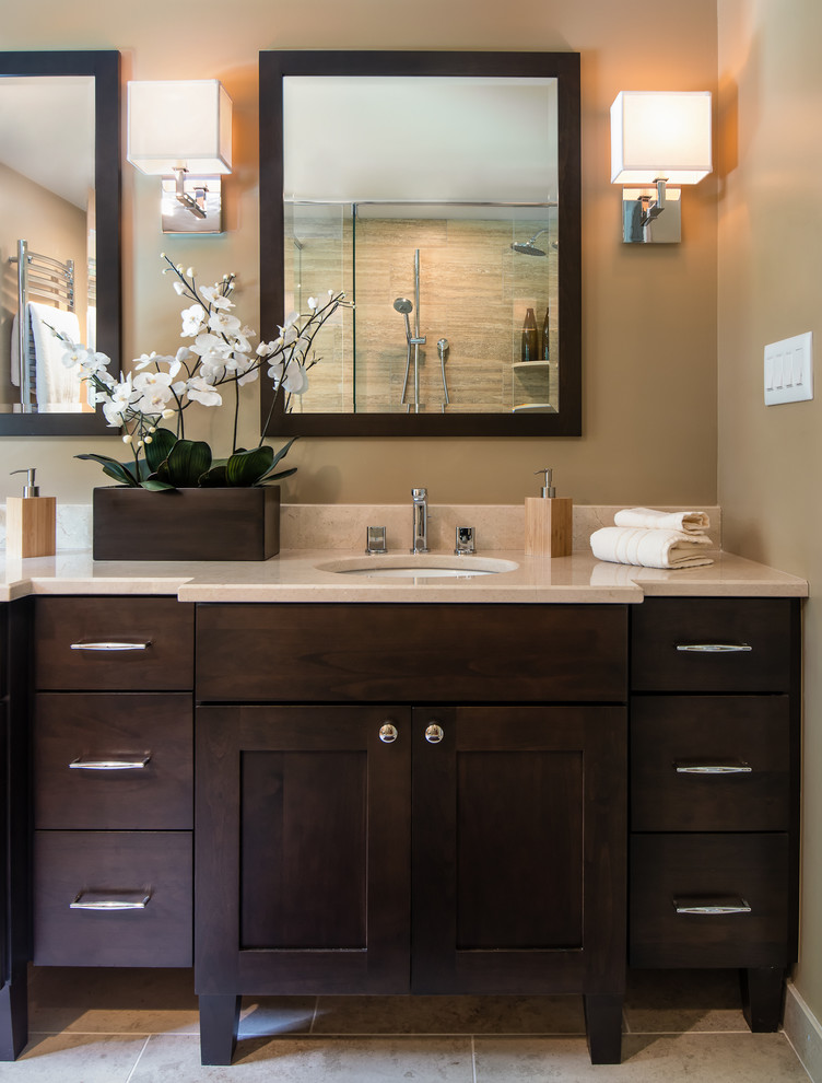 Inspiration for a mid-sized contemporary master beige tile and porcelain tile porcelain tile and gray floor corner shower remodel in Detroit with an undermount sink, dark wood cabinets, marble countertops, a one-piece toilet, beige walls, a hinged shower door, beige countertops and shaker cabinets
