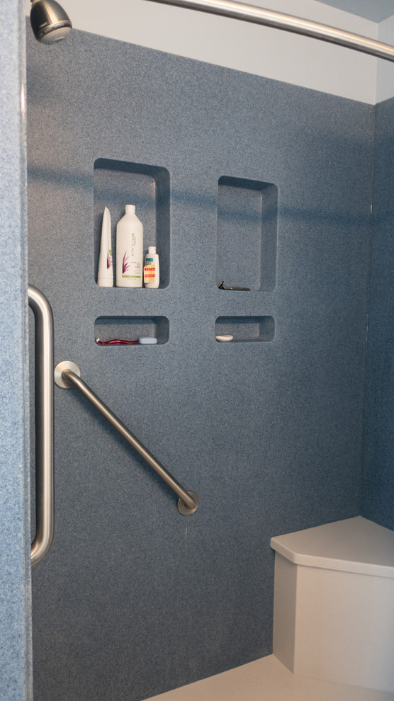 Photo of a medium sized contemporary shower room bathroom in Other with shaker cabinets, white cabinets, an alcove shower, a two-piece toilet, blue walls, lino flooring, an integrated sink, solid surface worktops, blue floors and a shower curtain.