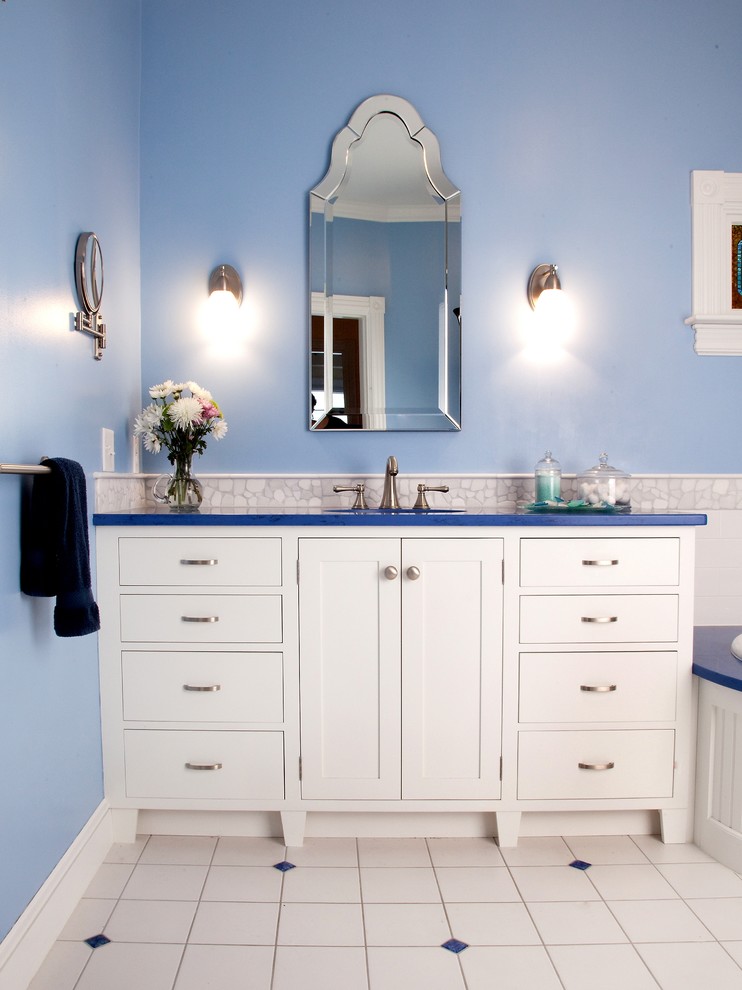 Example of a mid-sized classic master white tile and pebble tile ceramic tile corner bathtub design in Portland Maine with shaker cabinets, white cabinets, blue walls, an undermount sink and quartz countertops