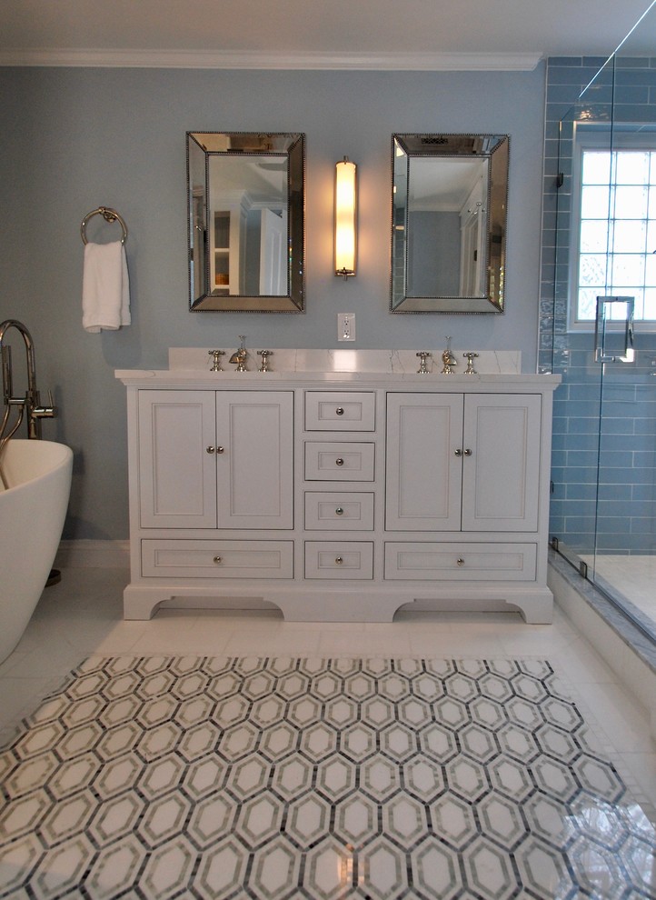 Design ideas for a medium sized classic ensuite bathroom in DC Metro with freestanding cabinets, white cabinets, a freestanding bath, an alcove shower, blue tiles, ceramic tiles, blue walls, marble flooring, a submerged sink, marble worktops, white floors, a hinged door and grey worktops.
