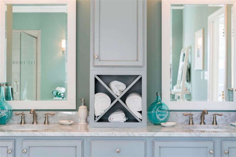 Inspiration for a contemporary corner shower remodel in Richmond with a console sink, raised-panel cabinets, blue cabinets, quartzite countertops, blue walls and a hinged shower door