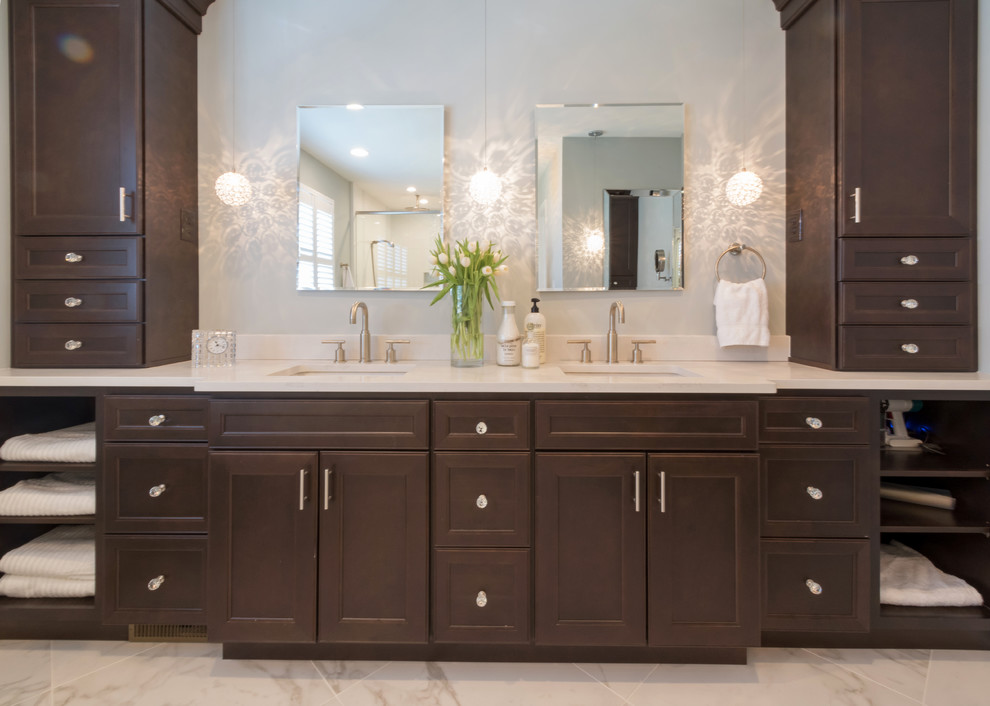 Bathroom - modern master marble floor and white floor bathroom idea in Philadelphia with recessed-panel cabinets, dark wood cabinets, blue walls, an undermount sink, marble countertops and a hinged shower door