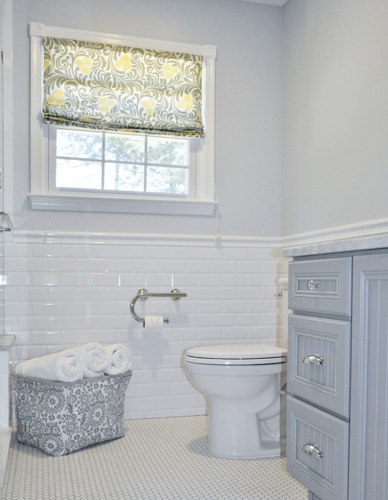 Photo of a small traditional ensuite bathroom in Philadelphia with recessed-panel cabinets, grey cabinets, marble worktops, an alcove shower, a two-piece toilet, white tiles, porcelain tiles, grey walls and mosaic tile flooring.