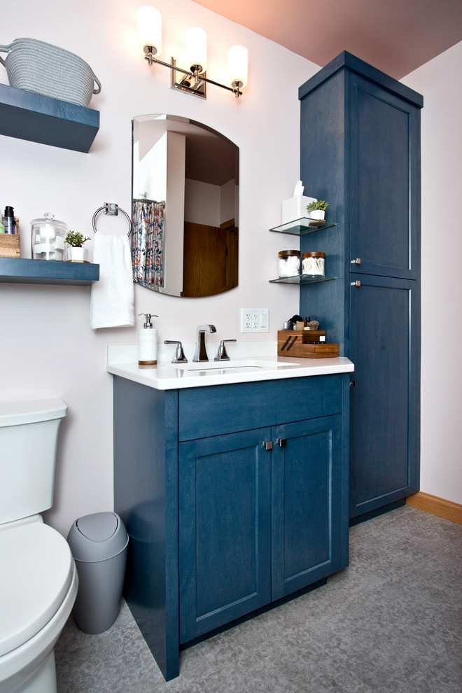 Inspiration for a small timeless 3/4 ceramic tile multicolored floor bathroom remodel in Minneapolis with recessed-panel cabinets, blue cabinets, a two-piece toilet, an undermount sink and white countertops