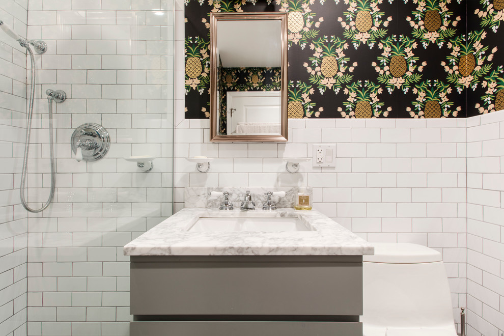 Photo of a medium sized contemporary shower room bathroom in New York with flat-panel cabinets, beige cabinets, an alcove shower, a one-piece toilet, white tiles, metro tiles, multi-coloured walls and a hinged door.