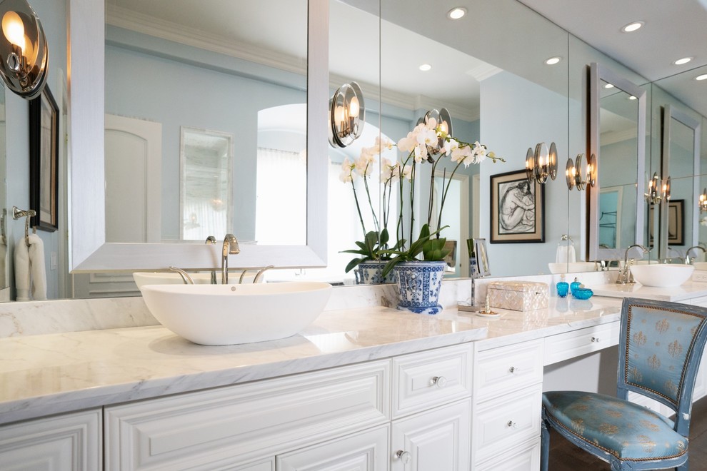 Bathroom - huge traditional master white tile and marble tile medium tone wood floor and brown floor bathroom idea in San Diego with raised-panel cabinets, white cabinets, a bidet, blue walls, a vessel sink, marble countertops, a hinged shower door and white countertops