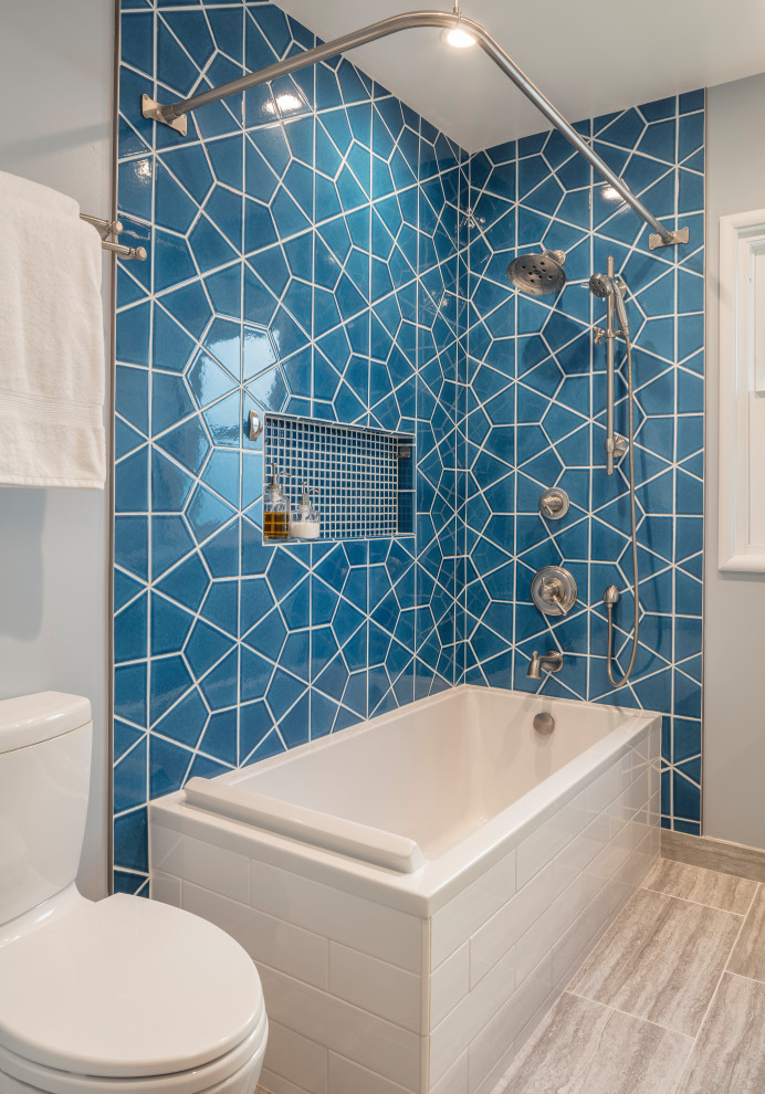 Aménagement d'une salle d'eau moderne de taille moyenne avec une baignoire d'angle, un combiné douche/baignoire, un carrelage bleu, des carreaux de céramique, un sol beige et aucune cabine.