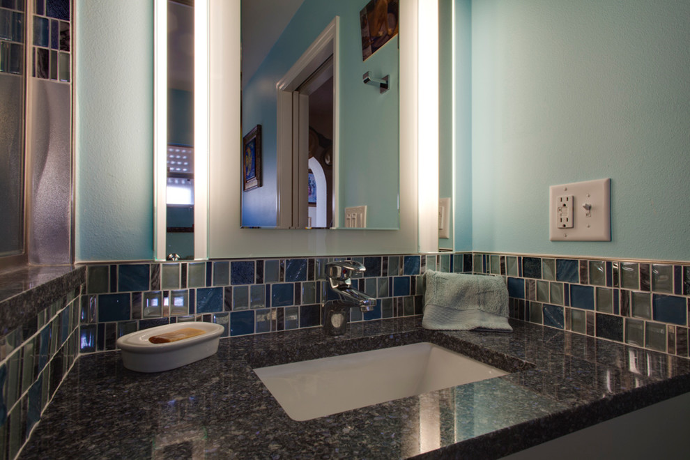 Example of a mid-sized urban 3/4 multicolored tile and mosaic tile marble floor and gray floor bathroom design in Tampa with flat-panel cabinets, white cabinets, blue walls, an undermount sink, granite countertops, a hinged shower door and a two-piece toilet