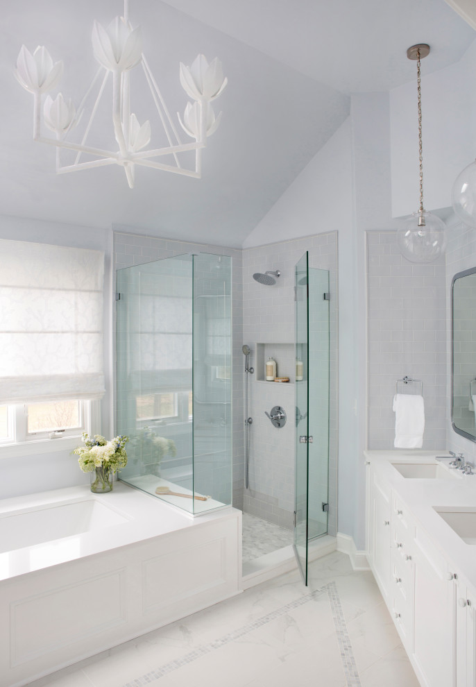 Example of a large transitional master blue tile and ceramic tile porcelain tile, gray floor, double-sink and vaulted ceiling bathroom design in Philadelphia with shaker cabinets, white cabinets, an undermount tub, a two-piece toilet, blue walls, an undermount sink, quartz countertops, a hinged shower door, white countertops and a built-in vanity