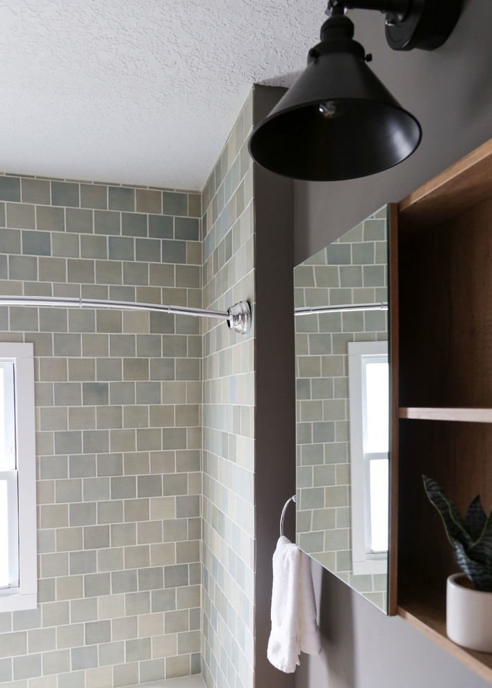 Inspiration for a small transitional 3/4 blue tile and ceramic tile ceramic tile and black floor bathroom remodel in Minneapolis with shaker cabinets and gray walls