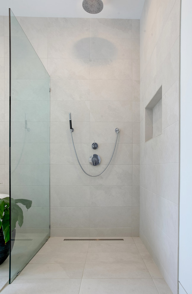 Mid-sized minimalist white tile and ceramic tile cement tile floor bathroom photo in Grand Rapids with flat-panel cabinets, black cabinets, white walls, an undermount sink and quartz countertops