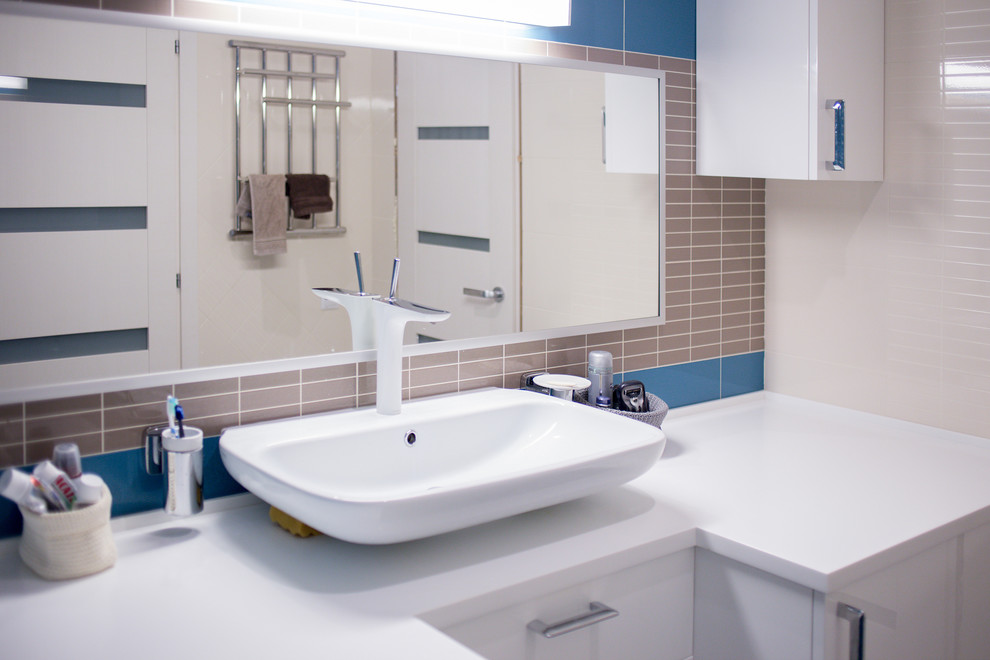 Large contemporary ensuite bathroom in Other with a wall-mounted sink, white cabinets, quartz worktops, a corner bath, a wall mounted toilet, beige tiles, ceramic tiles, multi-coloured walls and ceramic flooring.