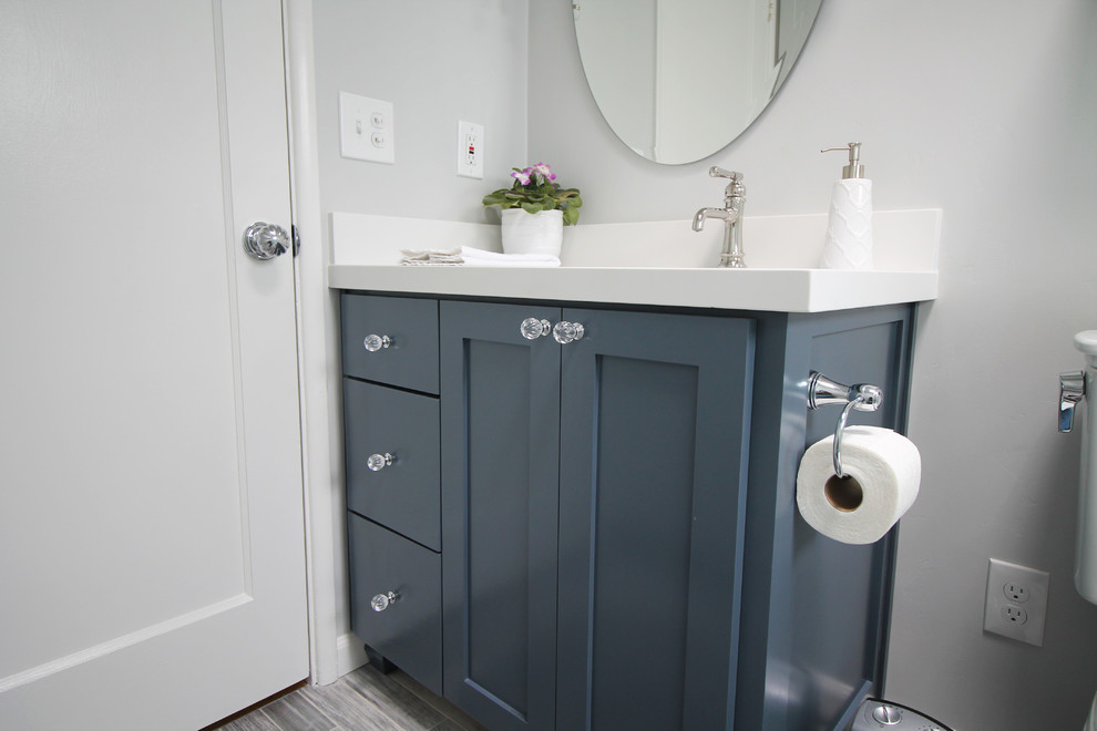 Photo of a small traditional bathroom in Sacramento with shaker cabinets, blue cabinets, grey tiles, metro tiles, grey walls, porcelain flooring, engineered stone worktops, grey floors and white worktops.