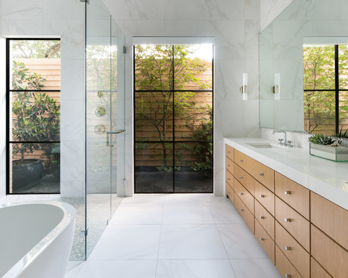 Contemporary bathroom with engineered wood vanity cabinets featuring Waterproof Technology and a glass shower enclosure