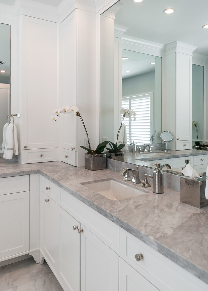 Inspiration for a large modern master white tile and stone tile marble floor bathroom remodel in Miami with a drop-in sink, raised-panel cabinets, white cabinets, marble countertops and white walls