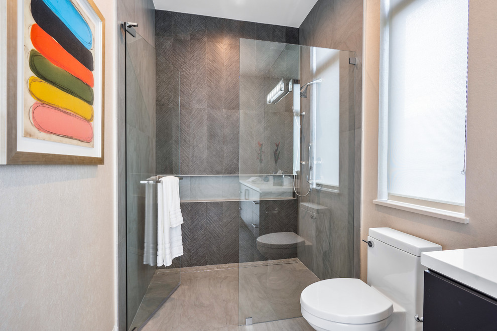 Large minimalist master white tile and stone slab porcelain tile and white floor doorless shower photo in Miami with flat-panel cabinets, dark wood cabinets, a one-piece toilet, beige walls, an undermount sink, onyx countertops and white countertops