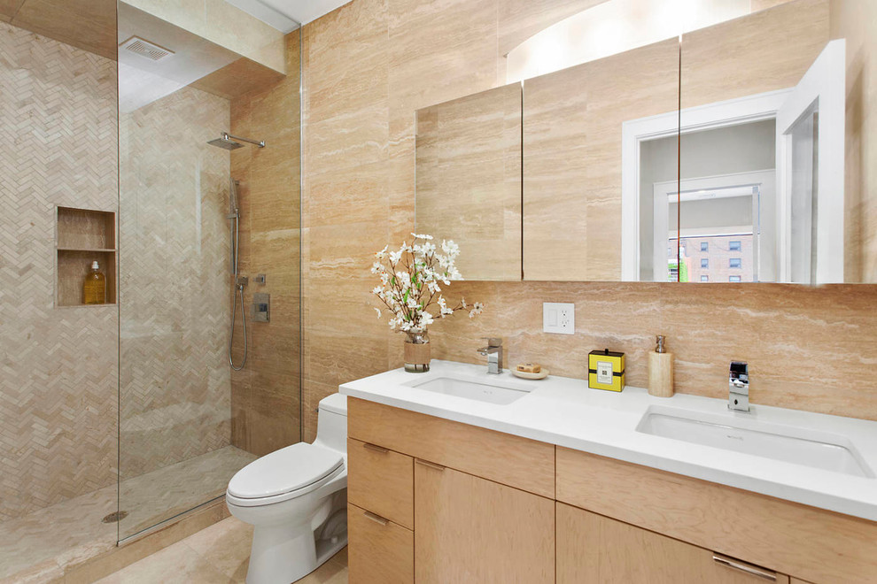 Inspiration for a medium sized modern shower room bathroom in New York with flat-panel cabinets, light wood cabinets, an alcove shower, a one-piece toilet, beige tiles, multi-coloured tiles, ceramic tiles, beige walls, ceramic flooring, a submerged sink, quartz worktops, beige floors and an open shower.