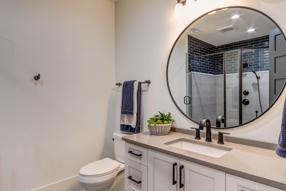 Medium sized farmhouse family bathroom in Atlanta with shaker cabinets, white cabinets, a two-piece toilet, blue tiles, porcelain tiles, white walls, porcelain flooring, a submerged sink, engineered stone worktops, a hinged door, grey worktops, a shower bench, a single sink and a built in vanity unit.