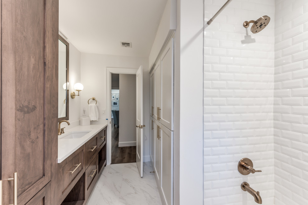 Inspiration for a mid-sized coastal kids' white tile and ceramic tile porcelain tile and white floor bathroom remodel in Houston with shaker cabinets, medium tone wood cabinets, a one-piece toilet, white walls, an undermount sink, quartzite countertops and white countertops