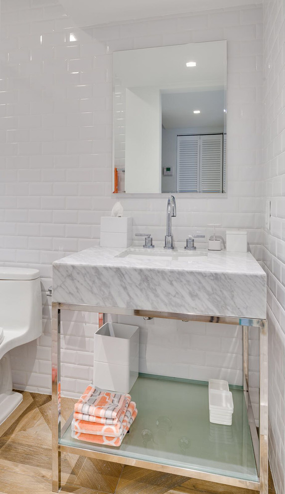 Mid-sized transitional 3/4 white tile and ceramic tile ceramic tile bathroom photo in Miami with open cabinets, gray cabinets, a one-piece toilet, white walls, a vessel sink and marble countertops