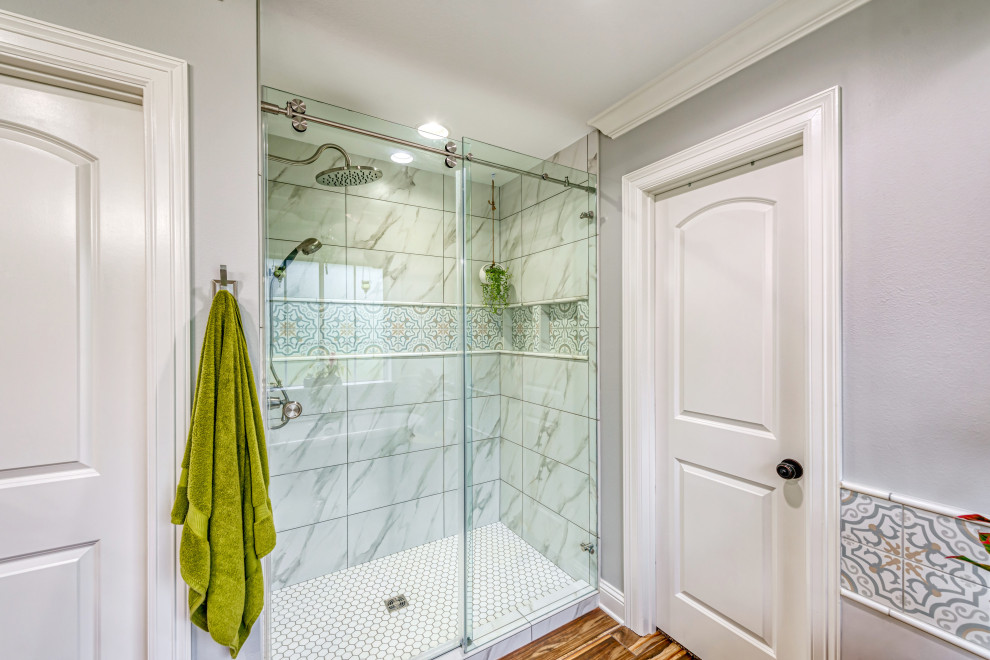 Mid-sized eclectic master multicolored tile and porcelain tile porcelain tile and brown floor bathroom photo in Other with raised-panel cabinets, black cabinets, a two-piece toilet, gray walls, a vessel sink, quartzite countertops and white countertops